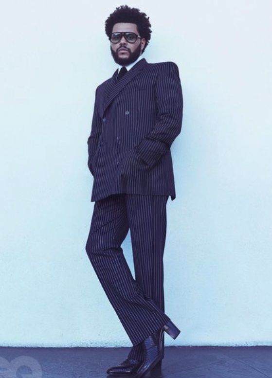 Image of The Weeknd from his GQ cover shoot in a pinstripe suit and python boots